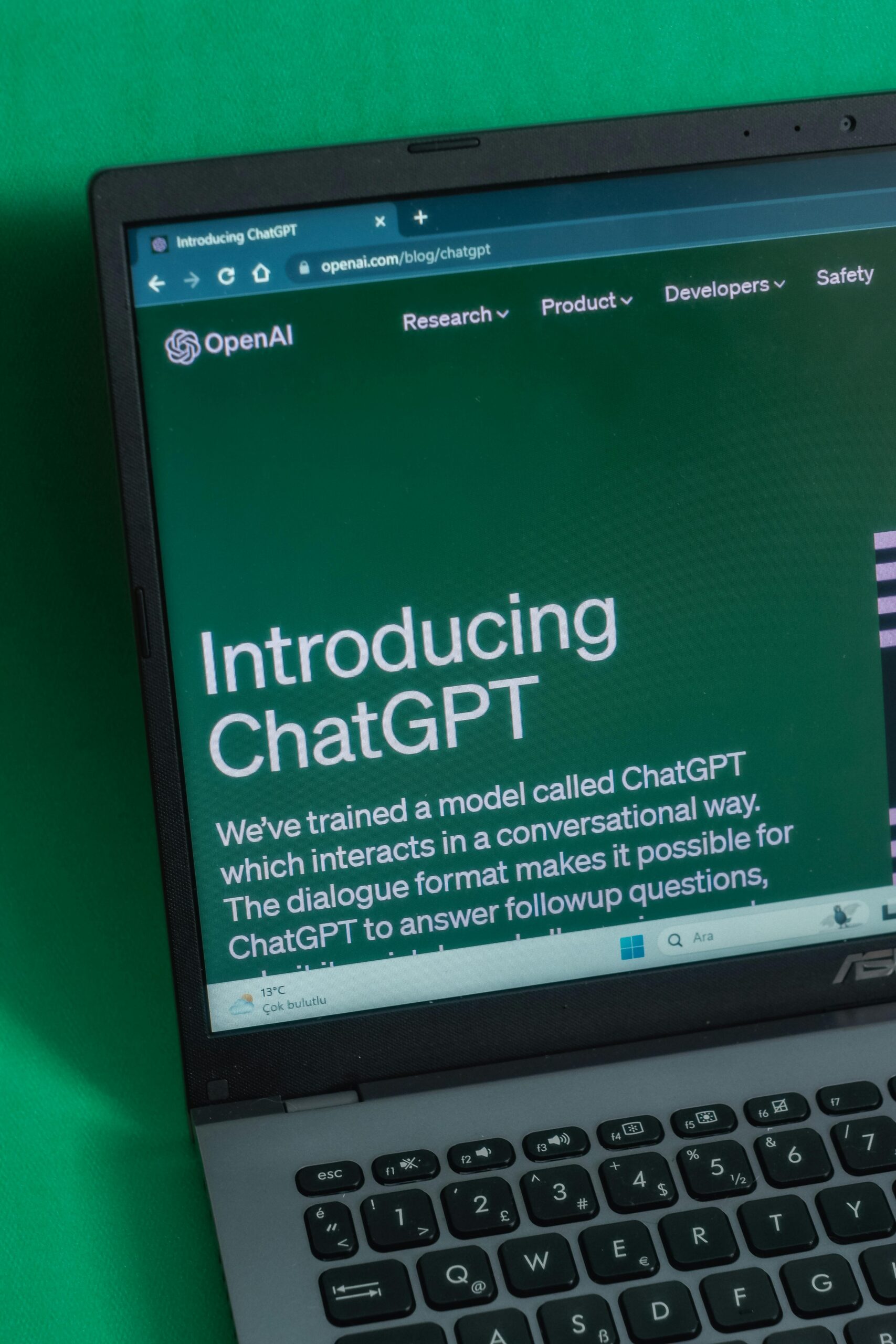 Laptop displaying ChatGPT introduction page on a web browser.